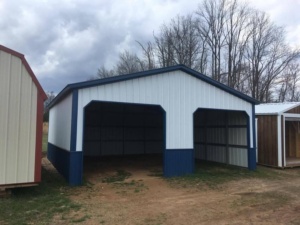 White metal garage with blue trim and two open bays