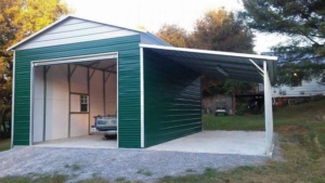 Green metal garage with a lean-to carport