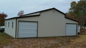 Tan metal garage with two roll-up doors