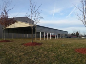 Long open metal carport with a lean-to