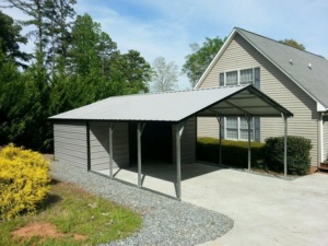 Metal carport with a storage side next to a home