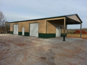 Tan and green metal building with a lean-to